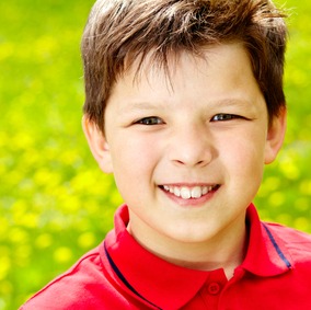 Close-up portrait of happy boy outside