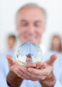 Senior businessman holding a crystal ball