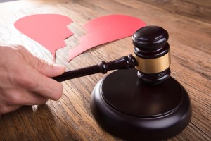 Divorce Judge With Broken Heart At Desk Hitting Gavel